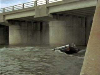 His car falls into the river!